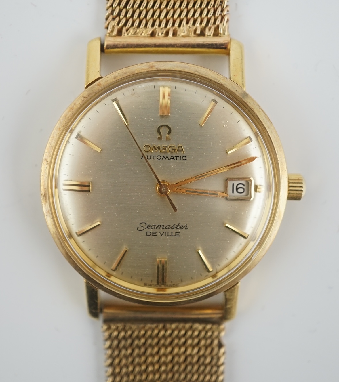 A gentleman's 1960's 18ct gold Omega Seamaster DeVille automatic wrist watch, on an associated 9ct gold bracelet